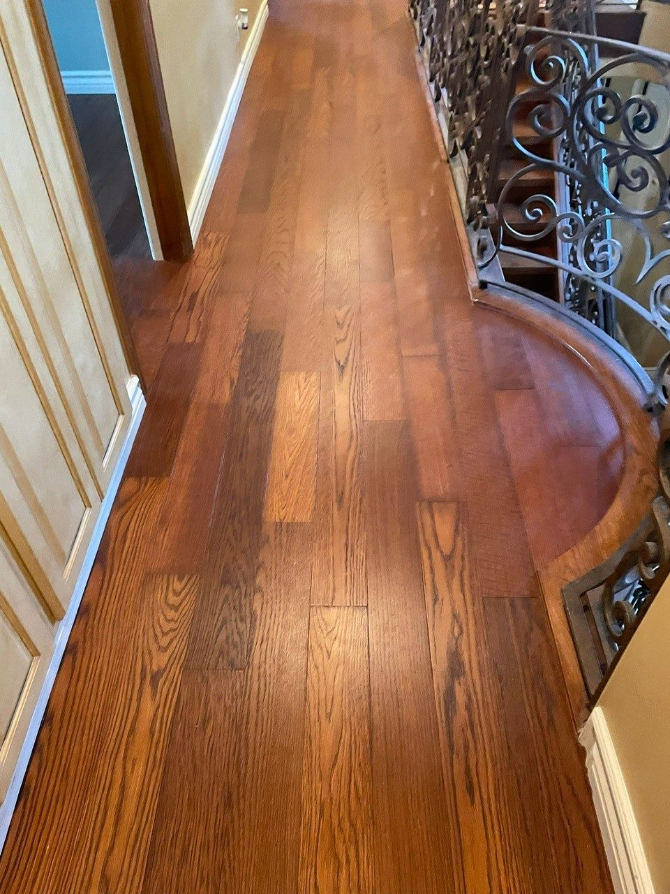 Refinished solid oak hardwood floors in a Fullerton home with traditional staircase by My Flooring Guy